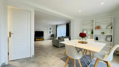 a living room with a white table and chairs at CASA CUCCHI in Porto-Vecchio