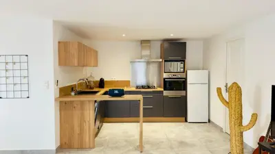 a kitchen with a sink and a refrigerator at CASA CUCCHI in Porto-Vecchio