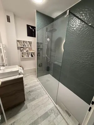 a bathroom with a shower with a glass shower stall at Grand Studio terrasse vue sur mer et parking in Ajaccio