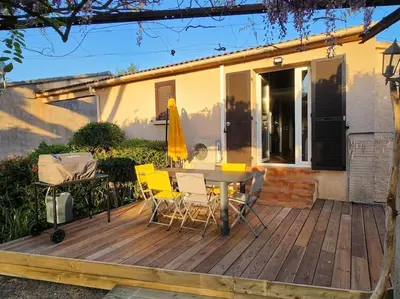 a wooden deck with a table and chairs on a house at Mini Villa Bord de Mer - Idylle BY MONARCA in San-Nicolao