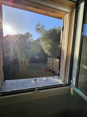 a window in a room with a view of a yard at Mini Villa Bord de Mer - Idylle BY MONARCA in San-Nicolao