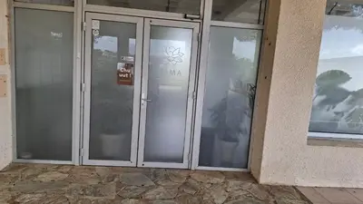 a pair of glass doors with a sign on them at TERRA BELLA 2 in Grosseto-Prugna