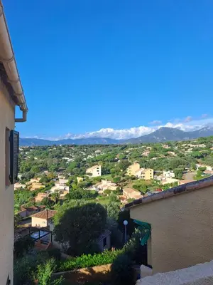 a view of a town with mountains in the distance at TERRA BELLA 2 in Grosseto-Prugna