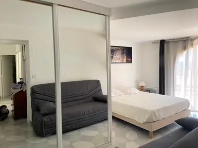 a bedroom with a bed and a couch at Villa Thamyris Porticcio Ajaccio Corse in Grosseto-Prugna
