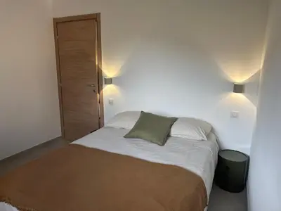 a bed in a bedroom with two lights on at CASA ALTEZZA in Soveria
