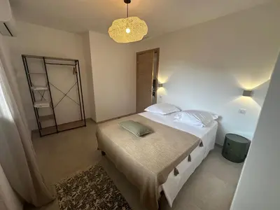 a bedroom with a large bed and a chandelier at CASA ALTEZZA in Soveria