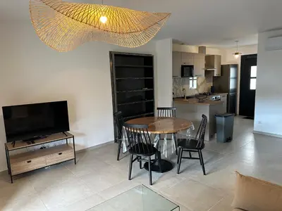 a living room with a table and chairs and a television at CASA ALTEZZA in Soveria