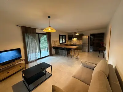 a living room with a couch and a tv and a kitchen at CASA ALTEZZA in Soveria