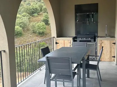 a table and chairs on a balcony with a stove at CASA ALTEZZA in Soveria