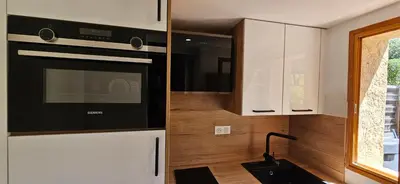 a kitchen with a stove and a microwave at Mini Caseddu T2, Piscine & vue mer, Alba Rossa N11 in Serra-di-Ferro