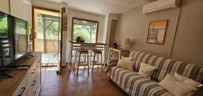 a living room with a couch and a table at Mini Caseddu T2, Piscine & vue mer, Alba Rossa N11 in Serra-di-Ferro