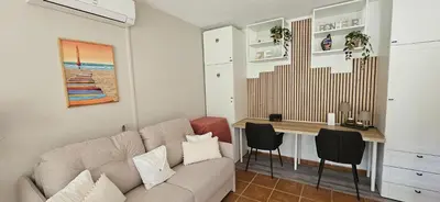 a living room with a couch and a desk at Mini Caseddu T2, Piscine & vue mer, Alba Rossa N11 in Serra-di-Ferro