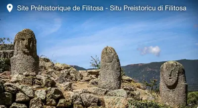 a group of stone statues sitting on top of a mountain at Villa Piazzola in Petreto-Bicchisano
