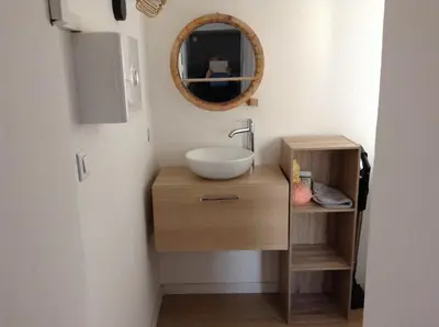 a bathroom with a sink and a mirror at la loggia in Porto-Vecchio