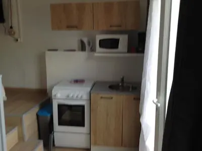 a small kitchen with a stove and a microwave at la loggia in Porto-Vecchio