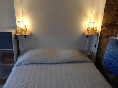a bedroom with a bed with two lights on it at la loggia in Porto-Vecchio