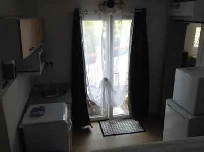 a room with a sliding glass door with a window at la loggia in Porto-Vecchio