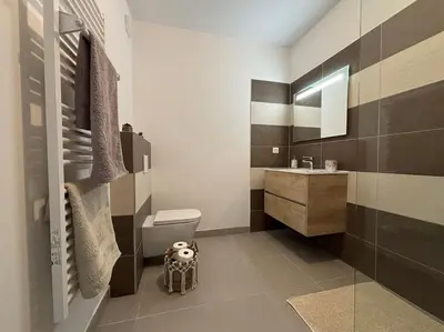 a bathroom with a toilet and a sink at Bel appartement T2 proche centre-ville et port in Porto-Vecchio