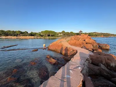 a body of water with rocks in the water at Bel appartement T2 proche centre-ville et port in Porto-Vecchio