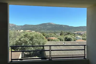a balcony with a view of a mountain view at Bel appartement T2 proche centre-ville et port in Porto-Vecchio
