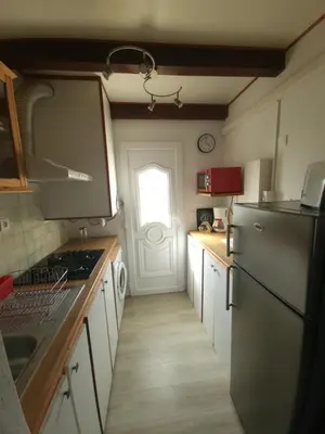a kitchen with a refrigerator and a door with a window at Villa Frati in Poggio-Mezzana