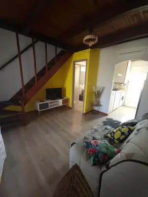 a living room with a couch and a staircase at Villa Frati in Poggio-Mezzana