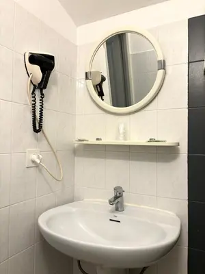 a bathroom with a sink and a mirror at HÖTEL U SANTA MARIA in Olmeto