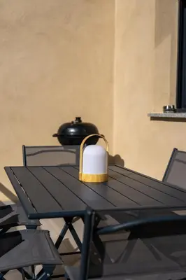 a black table with a candle on top of it at Casa Léa in Sollacaro