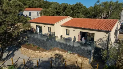 a small white house with a red roof at Casa Léa in Sollacaro