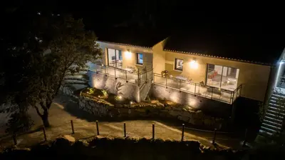 a house with lights on the side of it at night at Casa Léa in Sollacaro