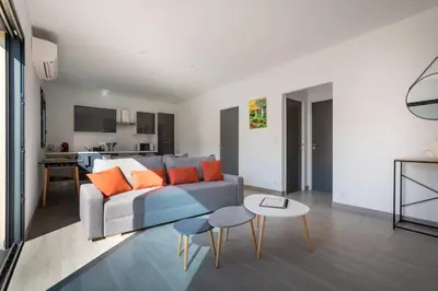 a living room with a couch and a table at Casa Léa in Sollacaro