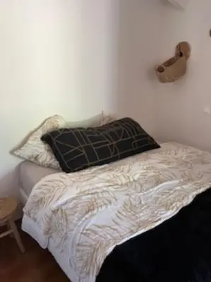 a bed with two pillows on it in a bedroom at Location Appartement Porticcio in Grosseto-Prugna