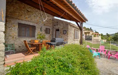 a patio with a table and chairs and a grill at 2 Bedroom Stunning Home In Popolasca in Popolasca