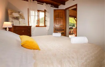a bedroom with a large white bed with yellow pillows at 2 Bedroom Stunning Home In Popolasca in Popolasca