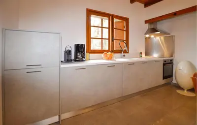 a kitchen with a stainless steel refrigerator and a window at 2 Bedroom Stunning Home In Popolasca in Popolasca