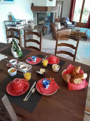 a wooden table with plates of food on it at Mare e Monti Chez Thomas et Magali in Vico