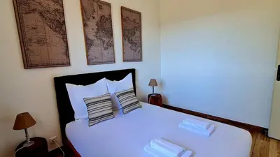 a bedroom with a white bed with two pillows on it at Bergerie A Sapara in Pianottoli-Caldarello