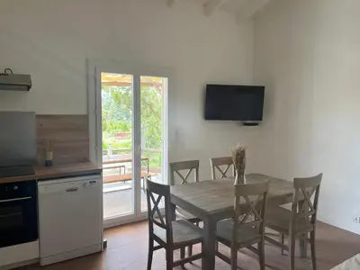 a kitchen and dining room with a table and chairs at E Casette Di Santa Giulia in Porto-Vecchio