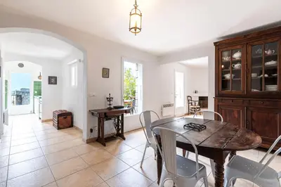 a kitchen and dining room with a table and chairs at Bergerie Piattone - Maison avec grand jardin in Pianottoli-Caldarello