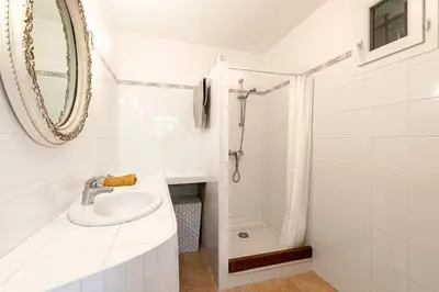 a white bathroom with a sink and a shower at Bergerie Piattone - Maison avec grand jardin in Pianottoli-Caldarello