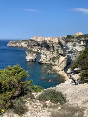 a large body of water next to a rocky coastline at Chalet maisonette dans hameau calme in Bonifacio