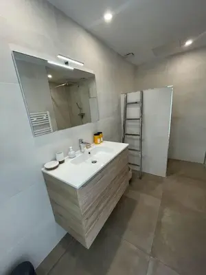 a bathroom with a sink and a mirror at Villa La Rondina vue mer, piscine et plage à pied. in Zonza