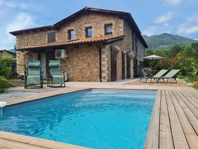 a house with a pool in front of a building at Holiday Home Mela by Interhome in Sotta