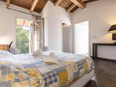 a bedroom with a large bed and a fireplace at Holiday Home Mela by Interhome in Sotta