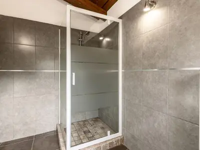 a shower with a glass door in a bathroom at Holiday Home Mela by Interhome in Sotta