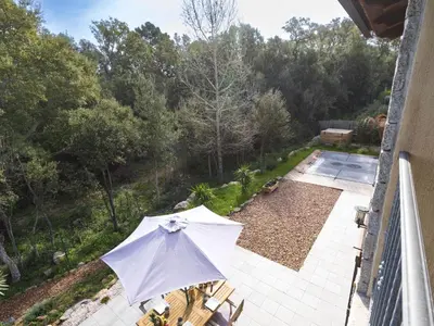 a white umbrella sitting on a balcony next to a patio at Holiday Home Mela by Interhome in Sotta