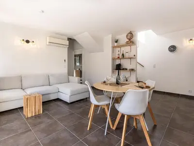 a living room with a couch and a table and chairs at Holiday Home Mela by Interhome in Sotta