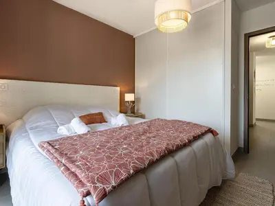 a bedroom with a large bed with a red blanket at Apartment Vignola 2 by Interhome in Porto-Vecchio