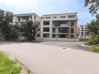 an empty parking lot in front of a building at Apartment Vignola 2 by Interhome in Porto-Vecchio