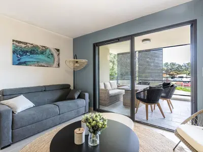 a living room with a couch and a table at Apartment Vignola 2 by Interhome in Porto-Vecchio